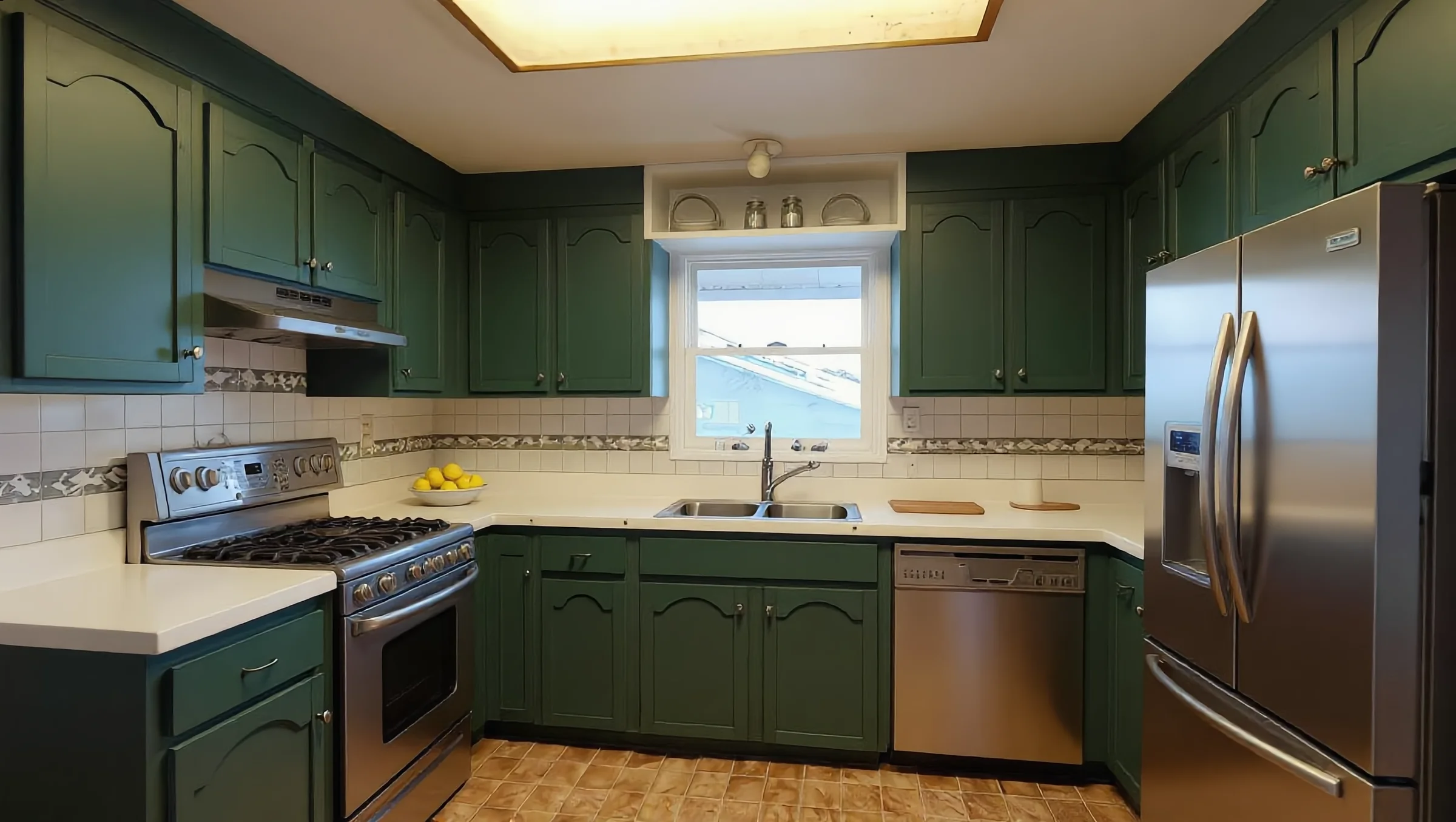 U-shaped kitchen with sage-green cabinets and stainless appliances