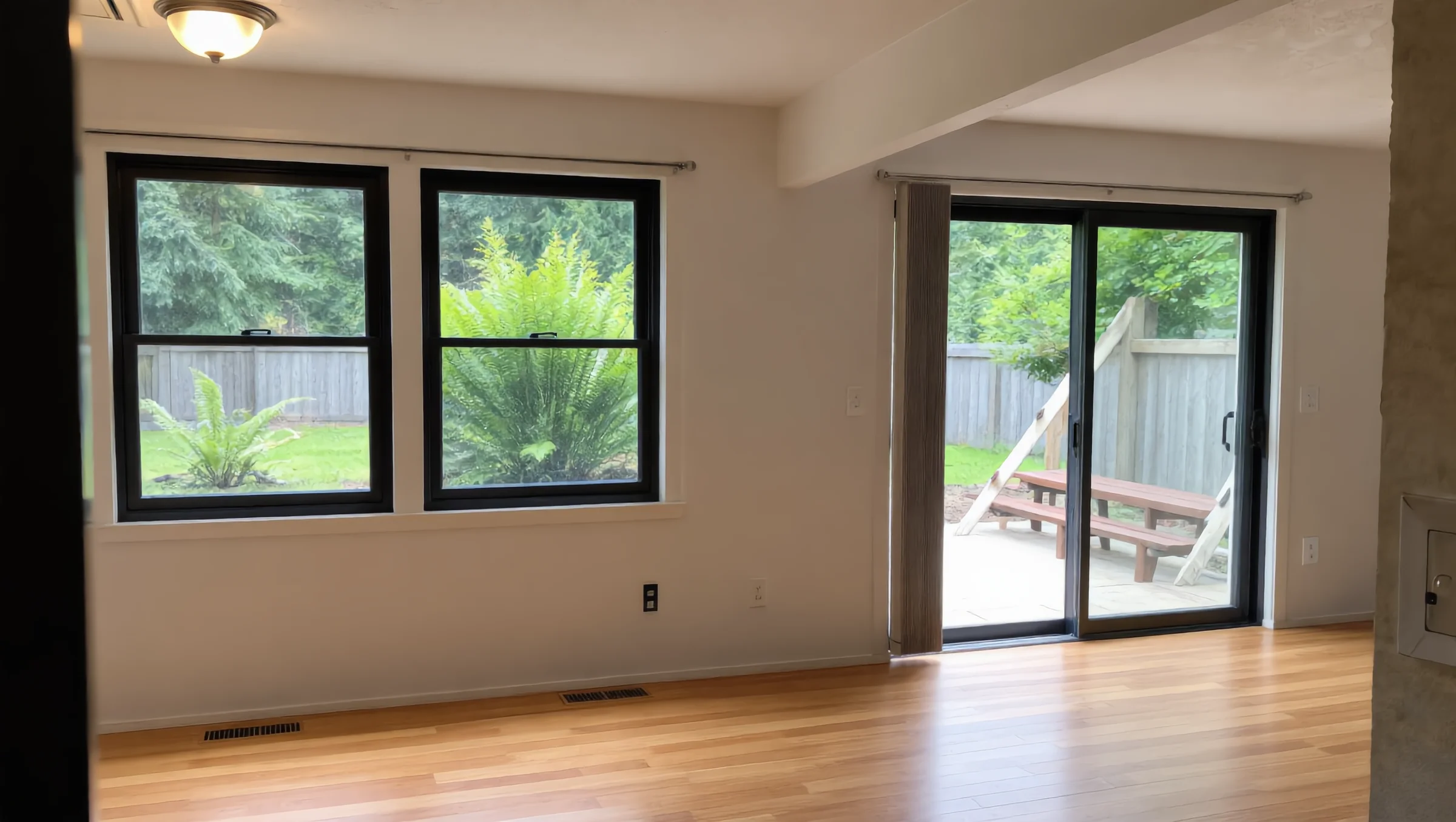Living room with new black-framed windows and sliding patio door